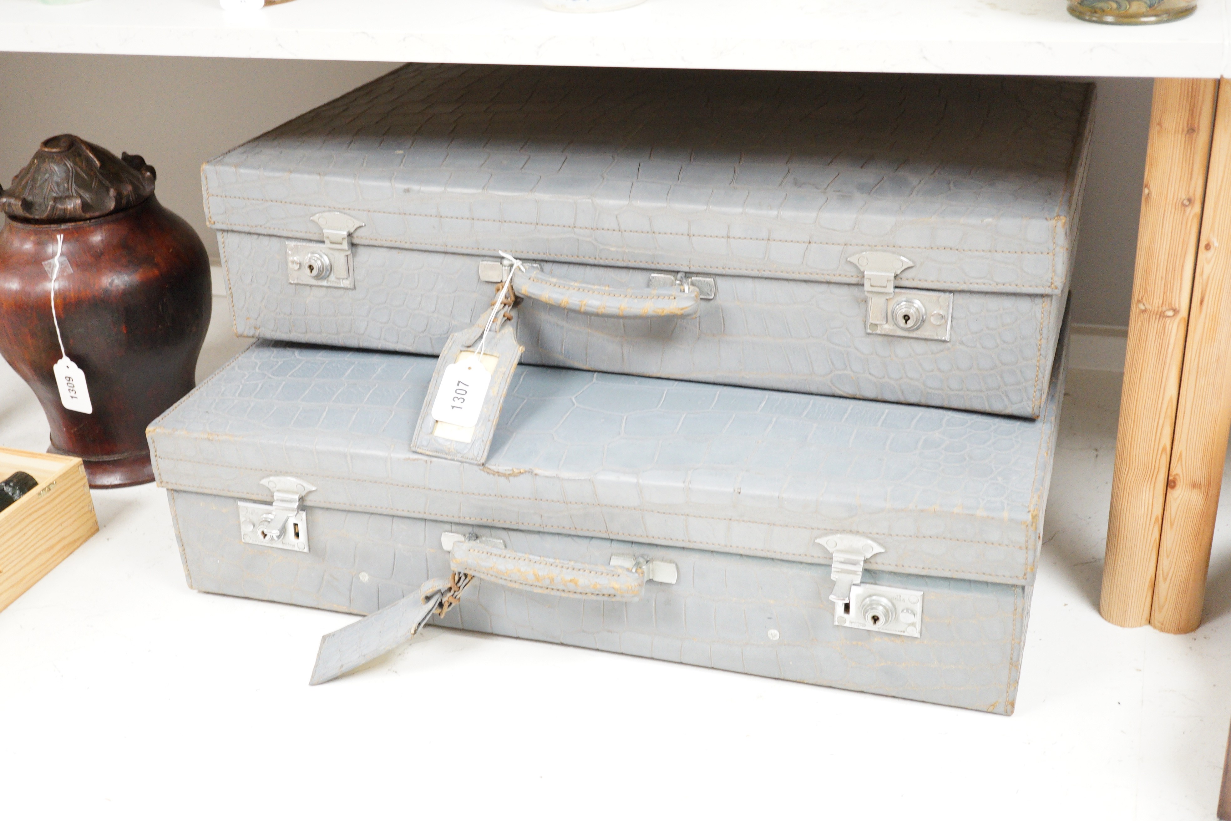 A pair of blue/grey faux crocodile suitcases